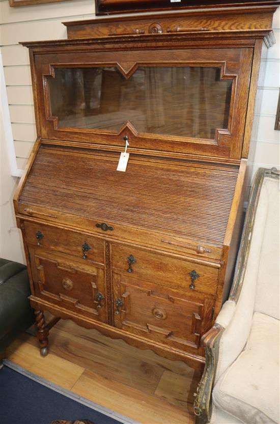 A 1920s oak tambour front desk W.87cm